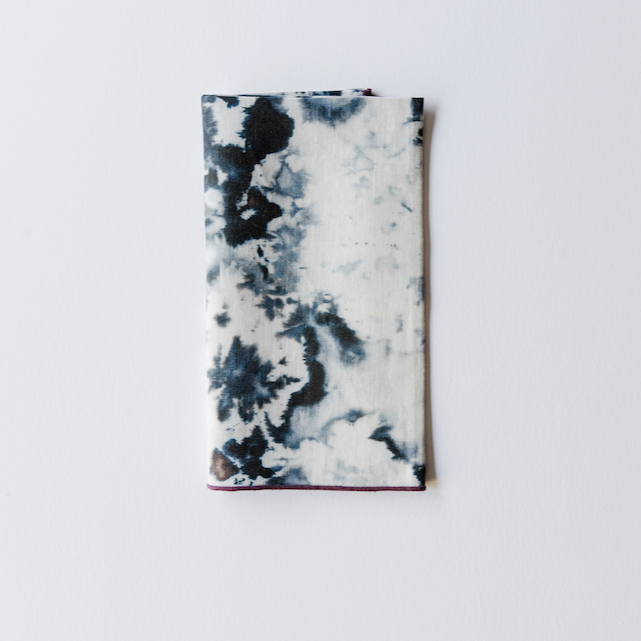 Marble print napkin in blue-gray with contrasting trim along border