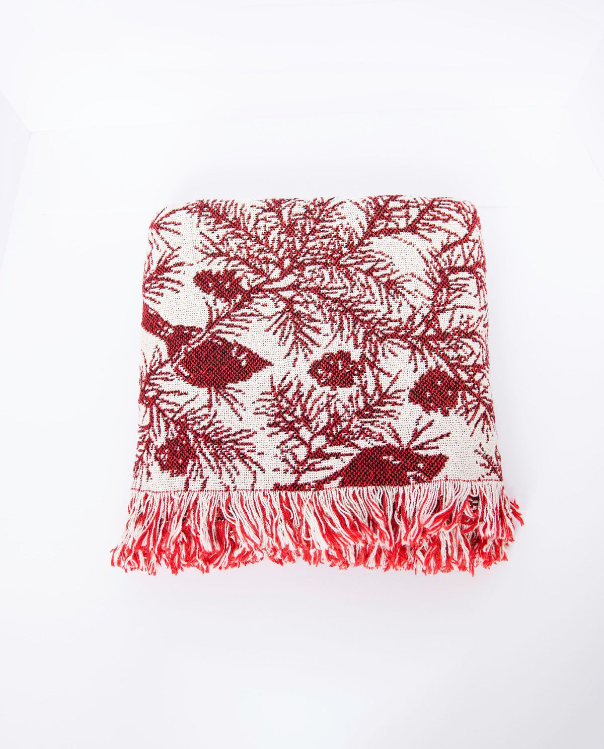 Cardinal-pattern jacquard throw in red and cream with decorative fringe border