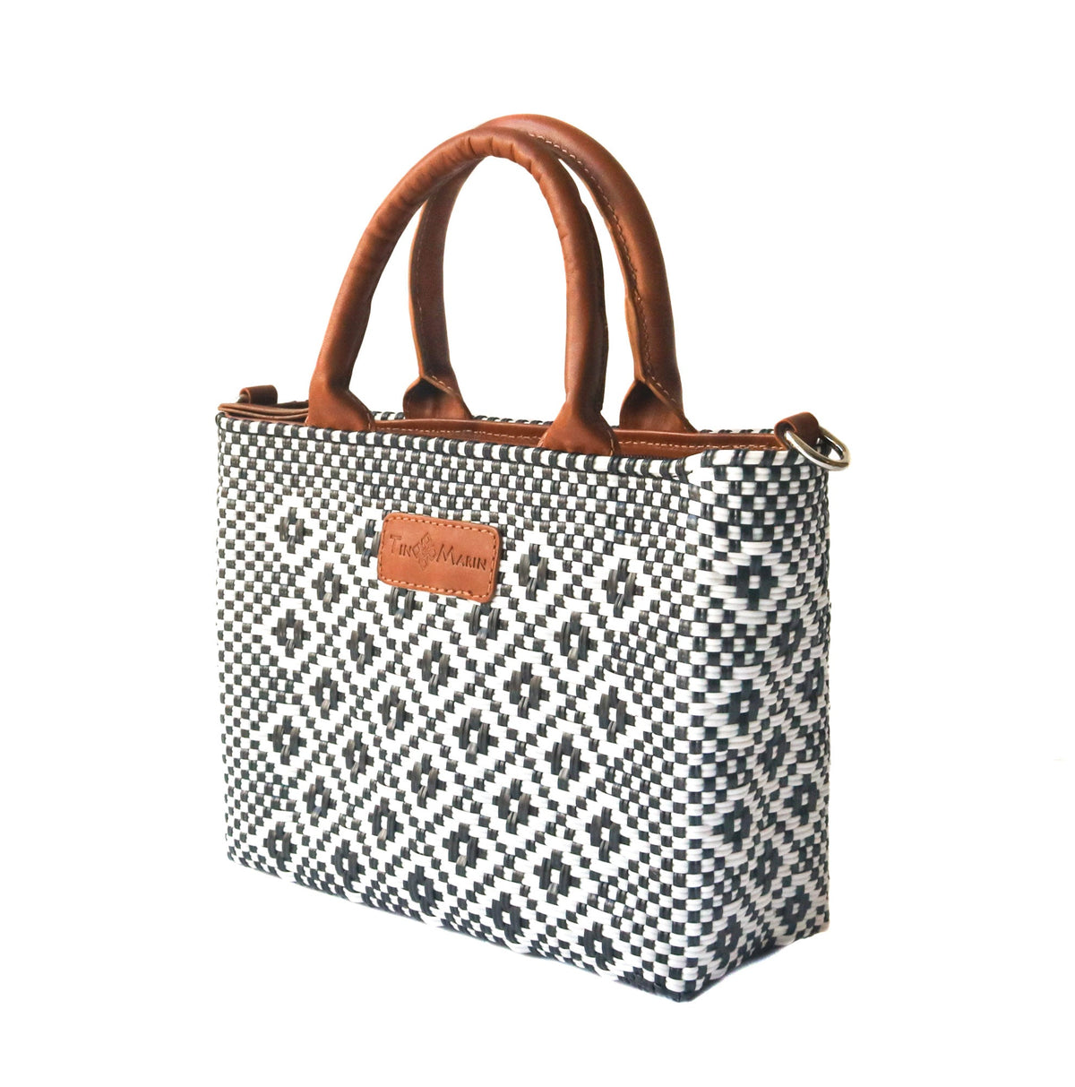 Small woven crossbody bag, black-and-white weave with tan leather top handles.