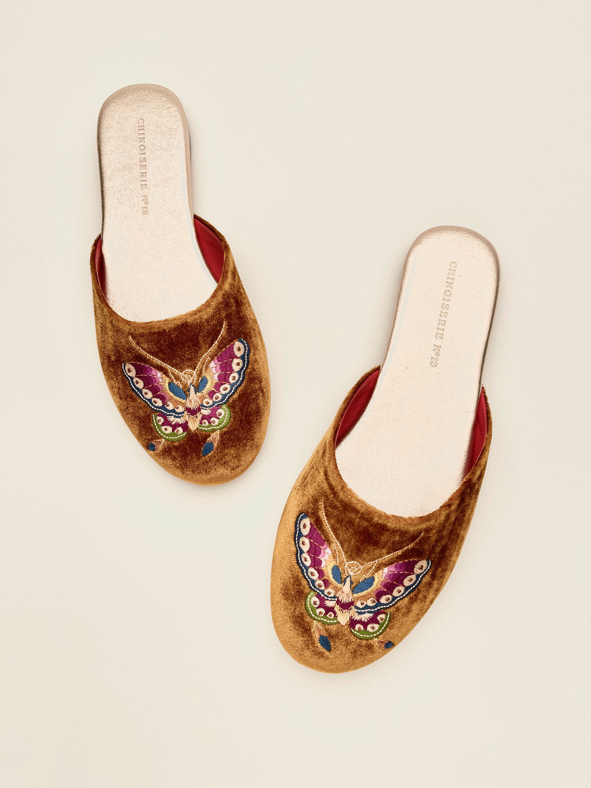 Pair of antique gold velvet mules with butterfly embroidery and red interior