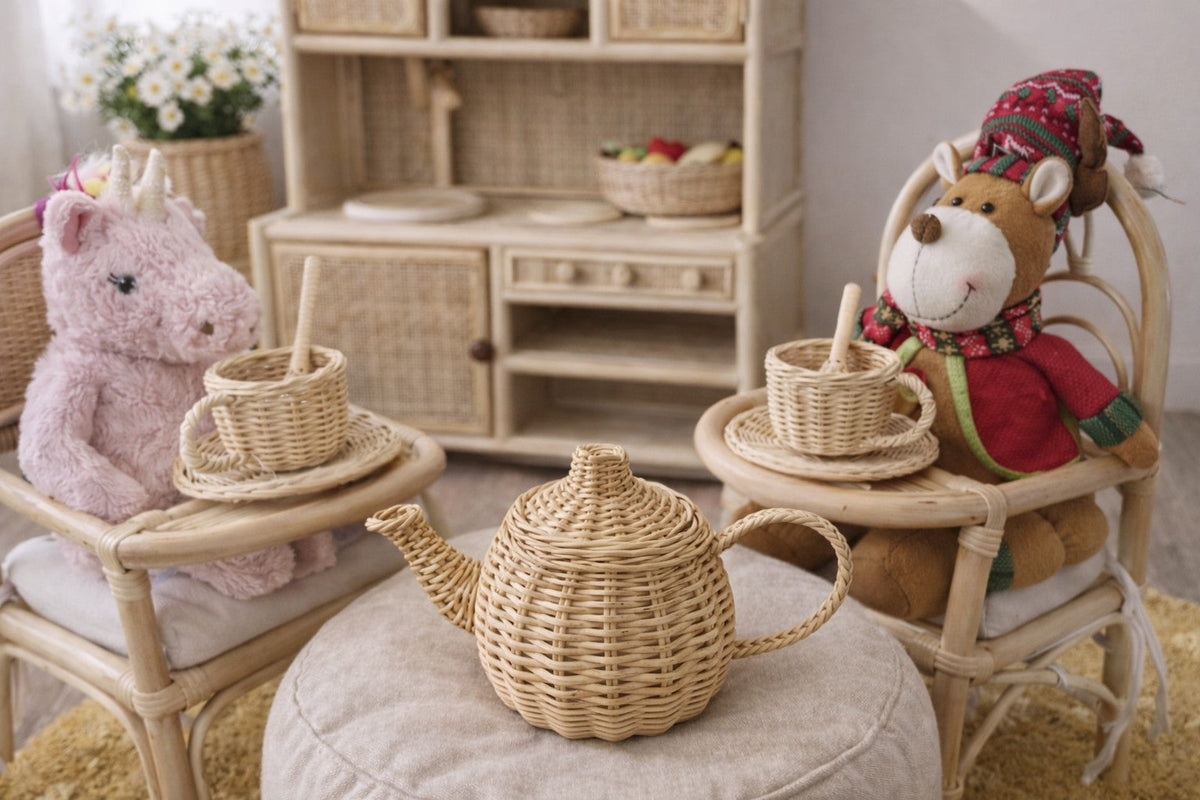 Wicker toy teapot displayed with cups and saucers on small chairs