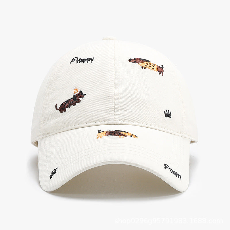 Beige baseball cap with curved brim and embroidered animal motifs