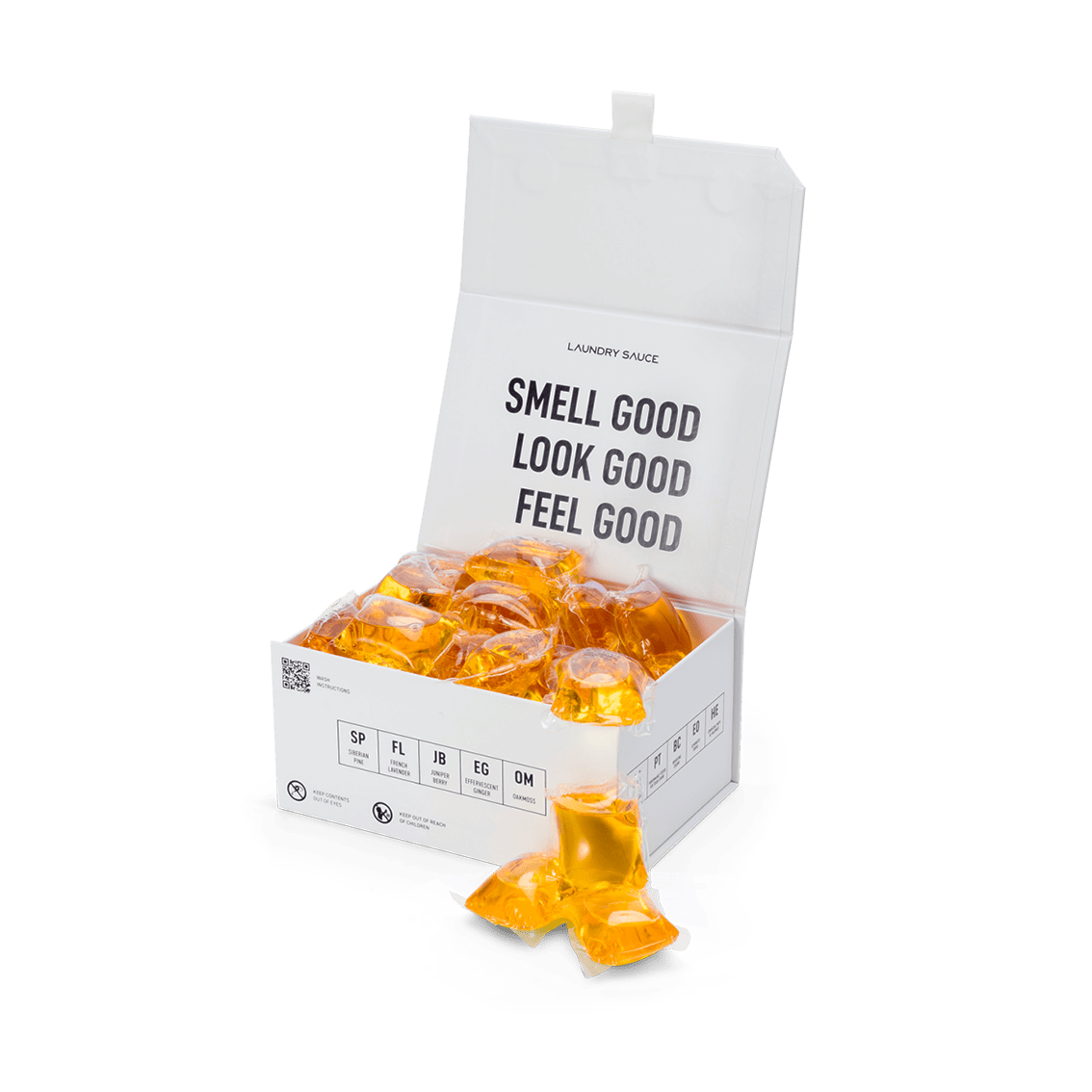 White box with amber scented detergent pods and a few pods on the side