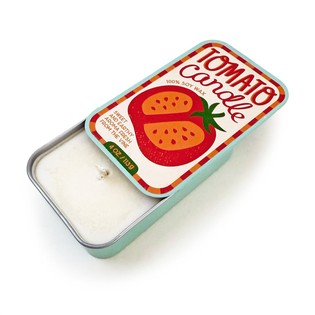 Tomato-scent soy candle tin with white wax surface and metal lid edge.