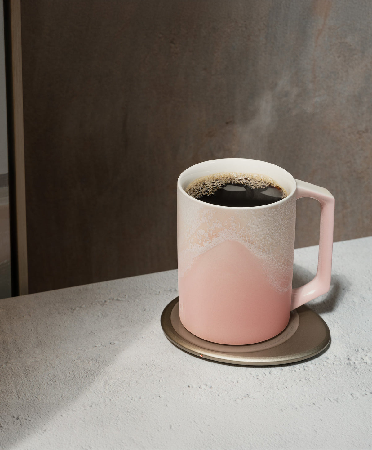 Artist mug set: pink ceramic mug with handle, filled with hot coffee