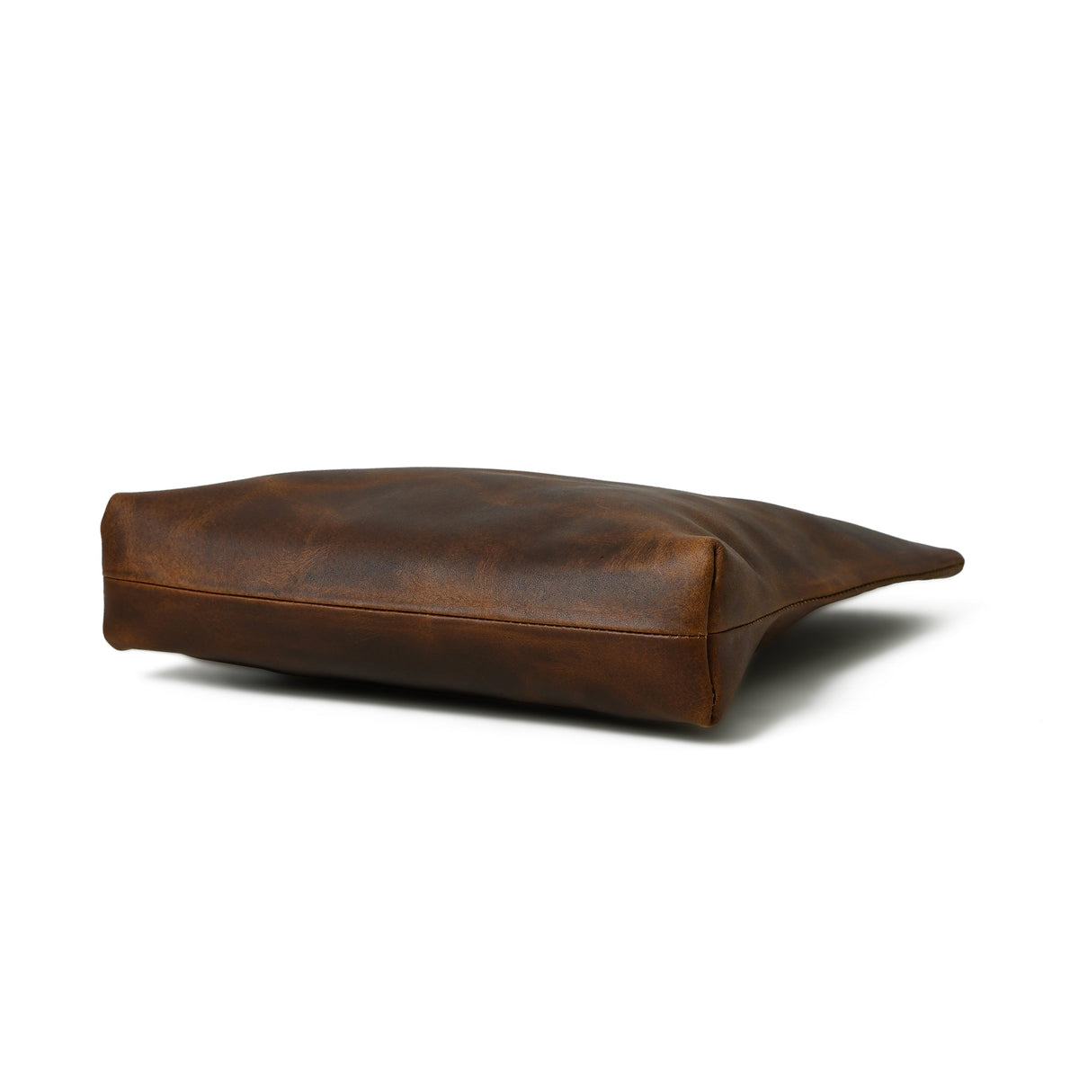 Brown leather handbag bottom view with flat base and stitched edge