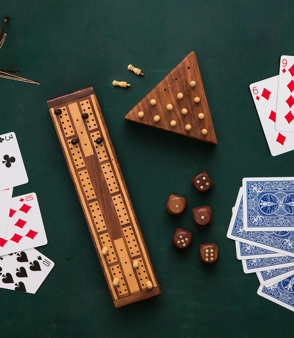 Wooden peg boards with scattered pegs and dice as part of the game set