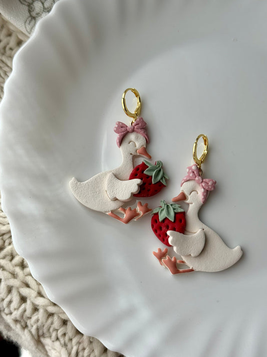 Pair of goose and strawberry charm earrings with gold-tone hoops
