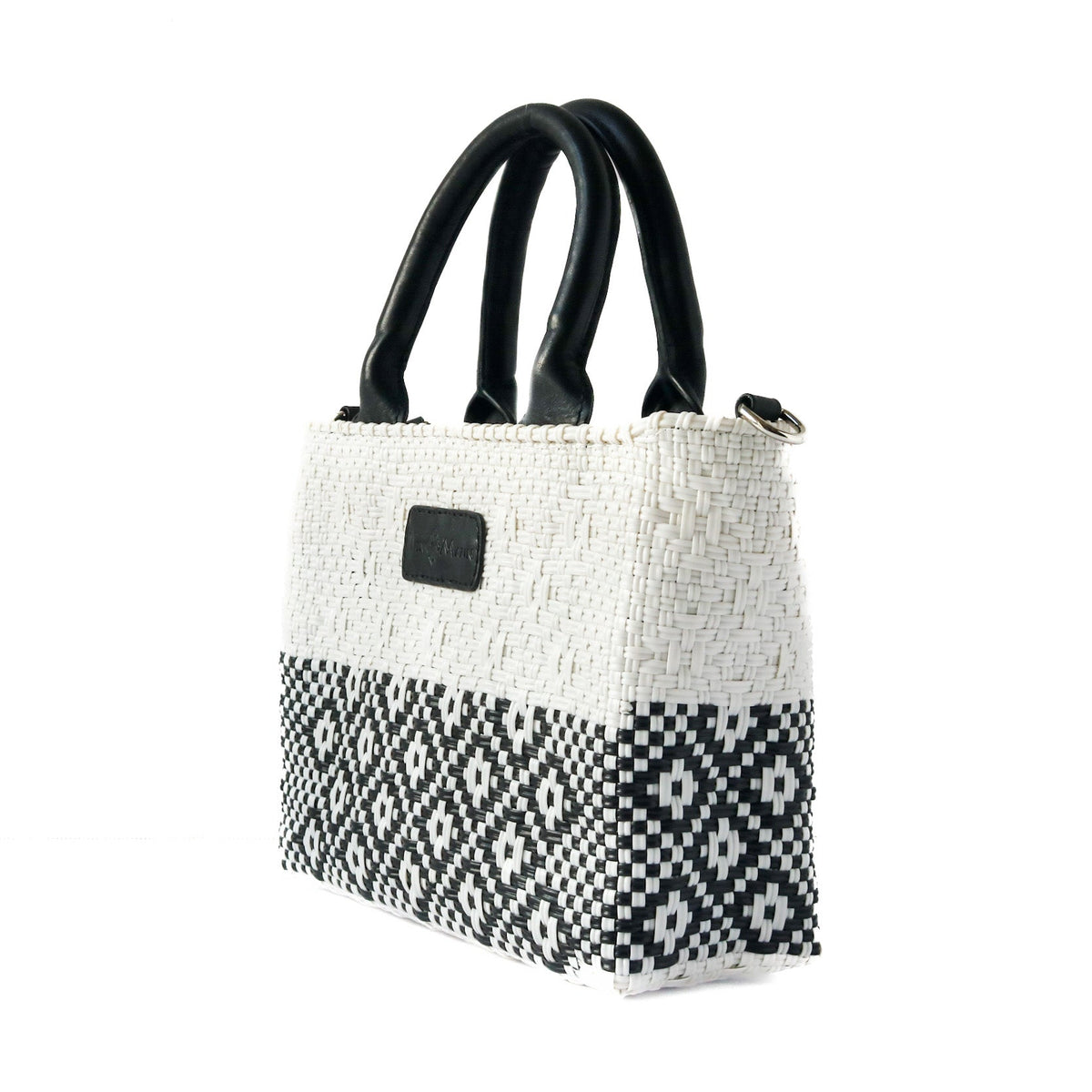 Small woven crossbody bag, black leather handles, white body with black geometric stripe