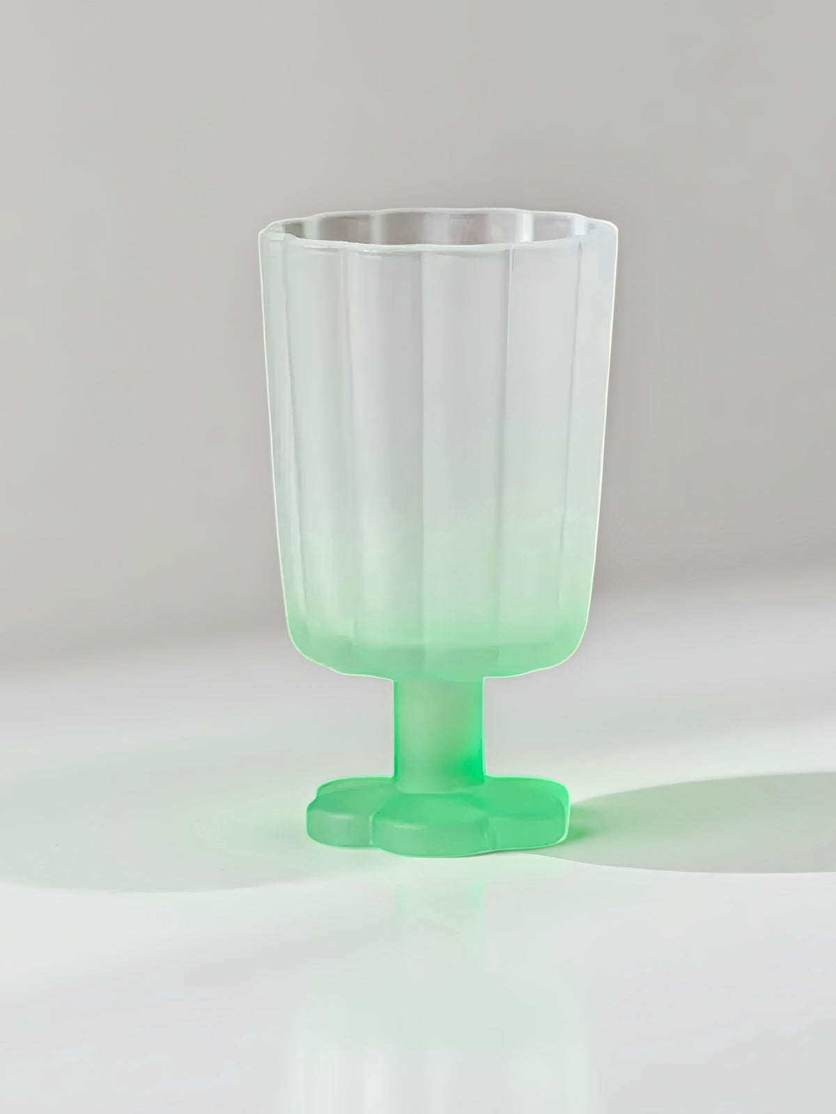 Hand-blown petal wine goblet with pale green ombre body and green foot.