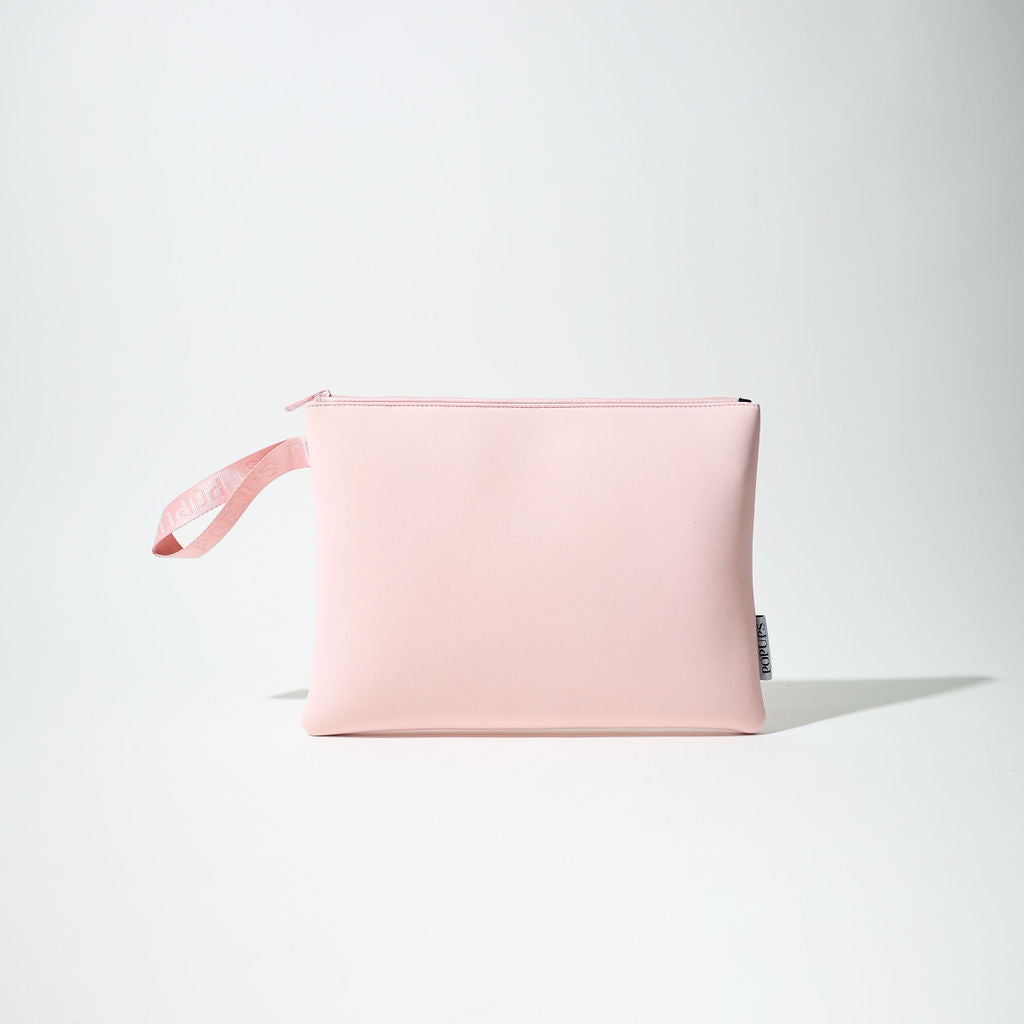 Pink laptop sleeve with zip closure and hanging ribbon tag, front view