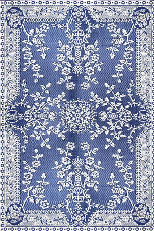 Blue and white patterned area rug with ornate floral border and central medallion.