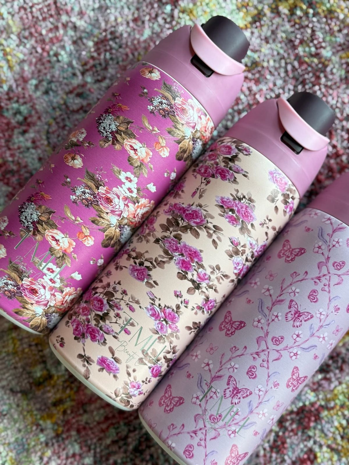 Floral insulated bottles with black flip-top lids, pink and cream patterned