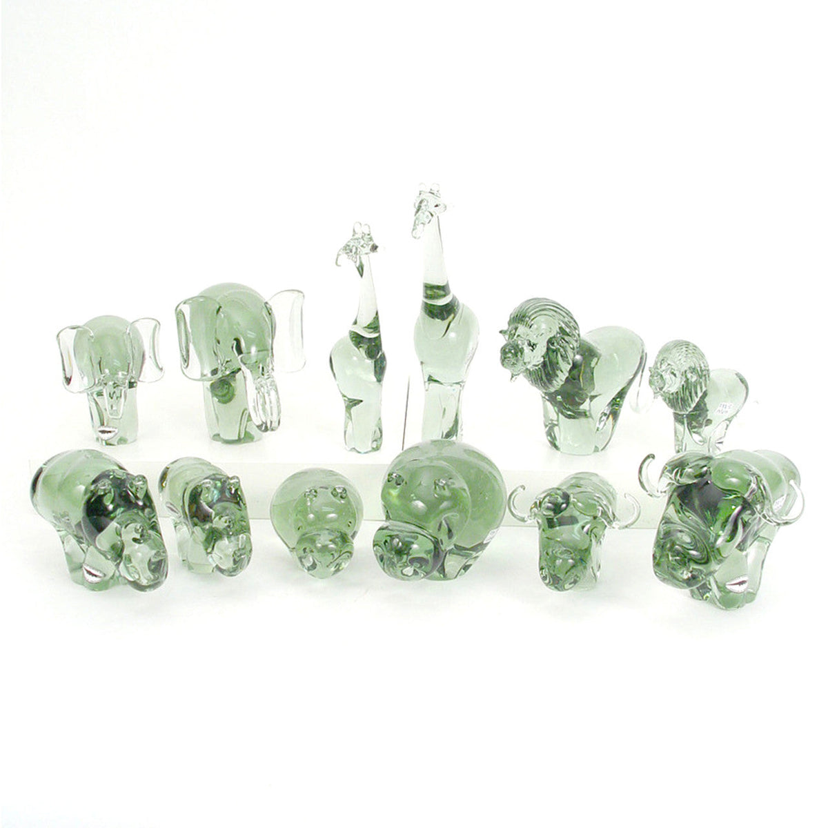 Assortment of green-tinted glass elephant figurines arranged in a row