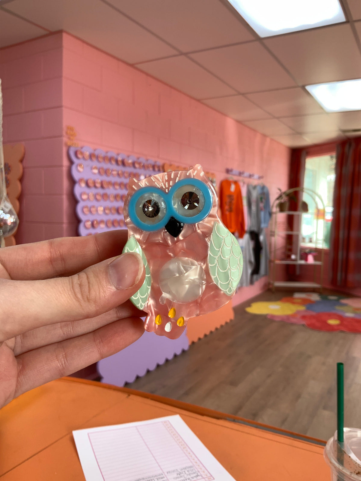 Owl hair claw with peach-pink body, blue eyes, orange feet, curved claw base