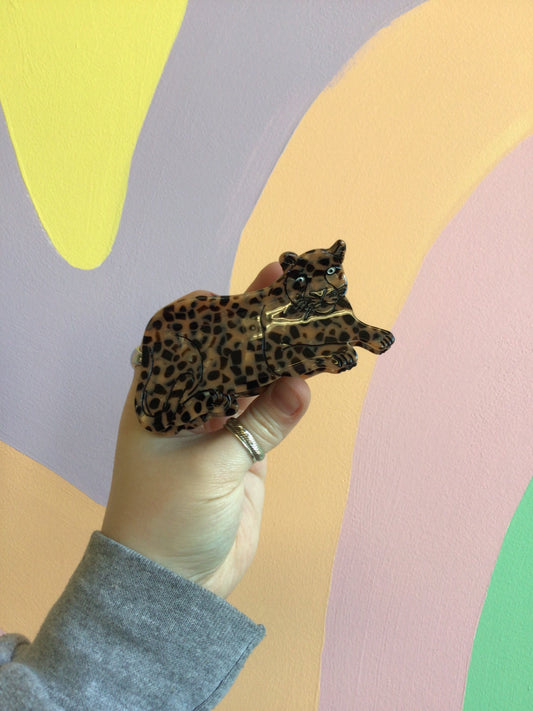 Jaguar-pattern hair claw figure with spotted body and open mouth detail