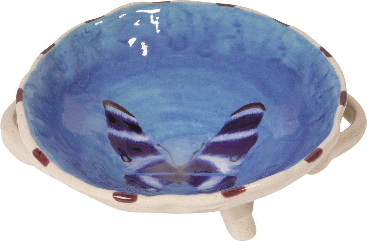 Blue footed ceramic bowl with animal face print and beige tripod legs