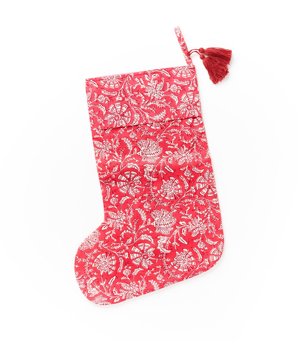 Red cotton holiday stocking with white hand-block print and hanging tassel loop