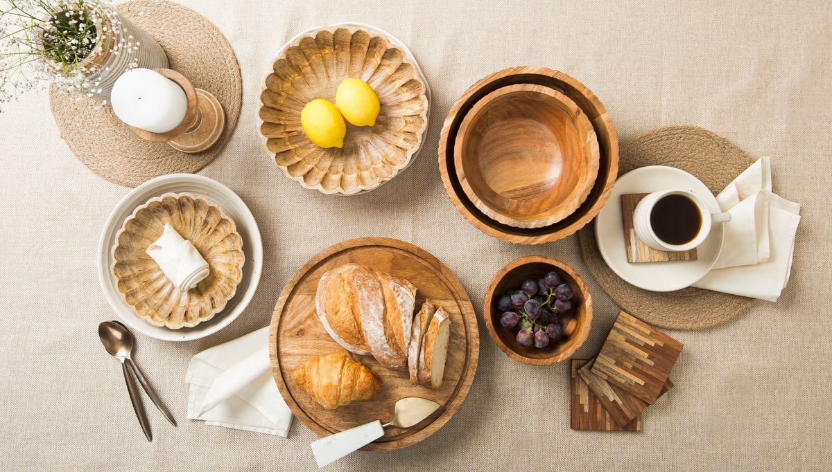 Set of scalloped natural wood bowls arranged for serving