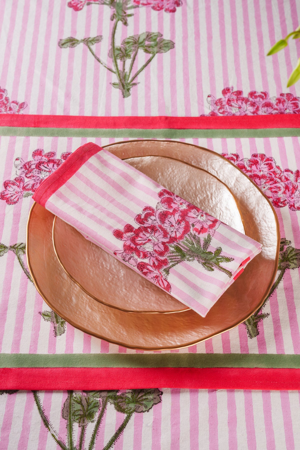 Pink striped blockprint napkins with hydrangea bouquet and red border trim