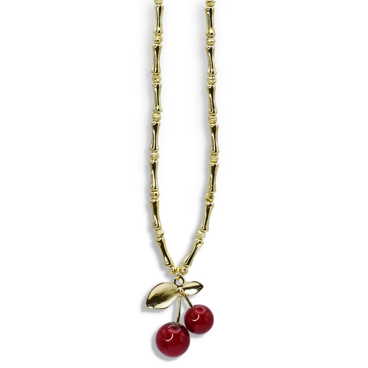 Gold-tone beaded chain necklace with leaf charm and two red cherry bead pendants