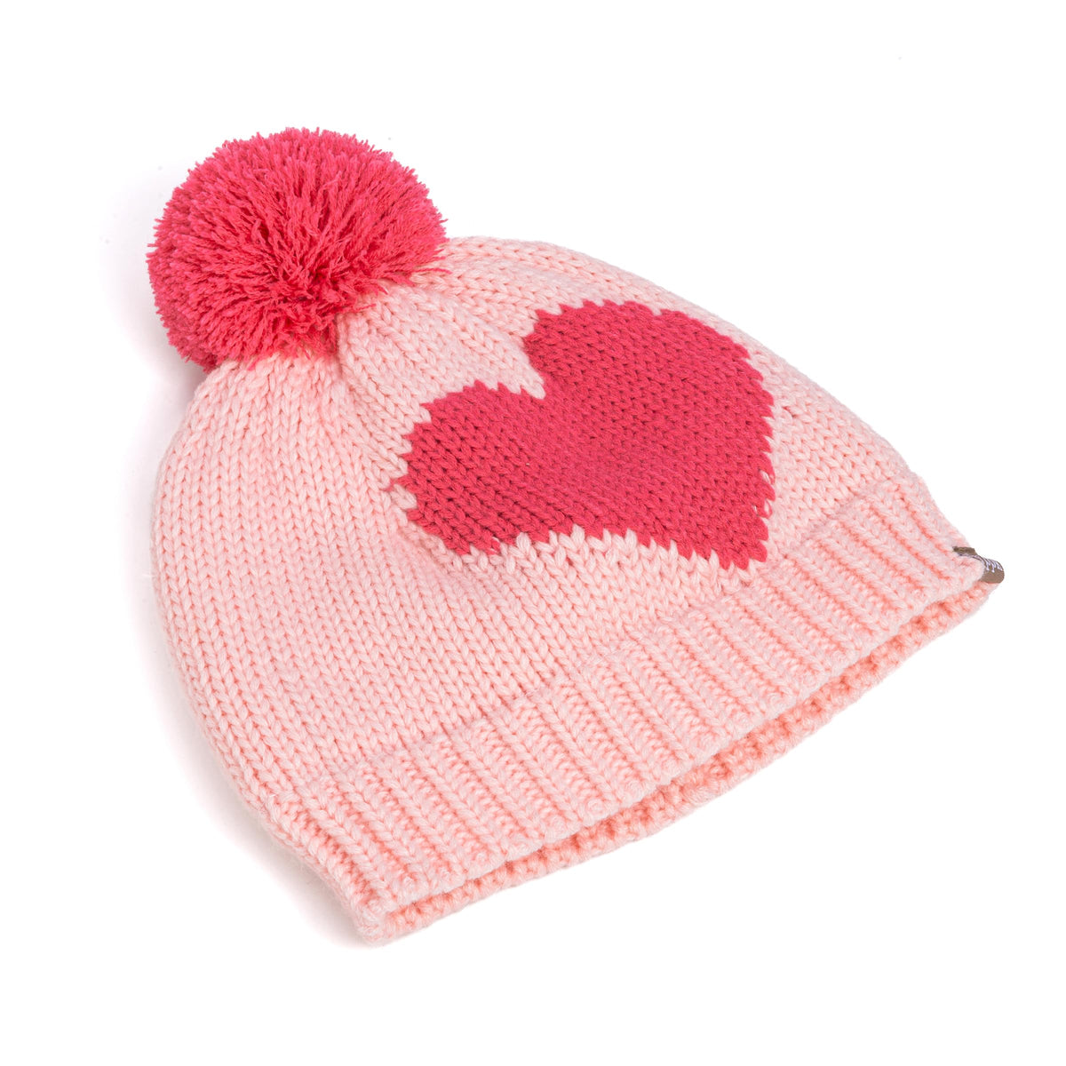 Side view of a pink knitted heart hat with ribbed brim and pom-pom