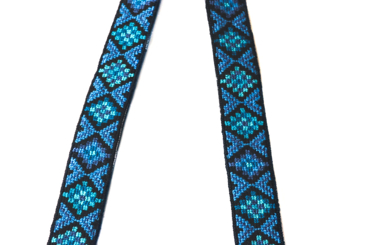 Blue woven strap with geometric diamond pattern on black-backed straps