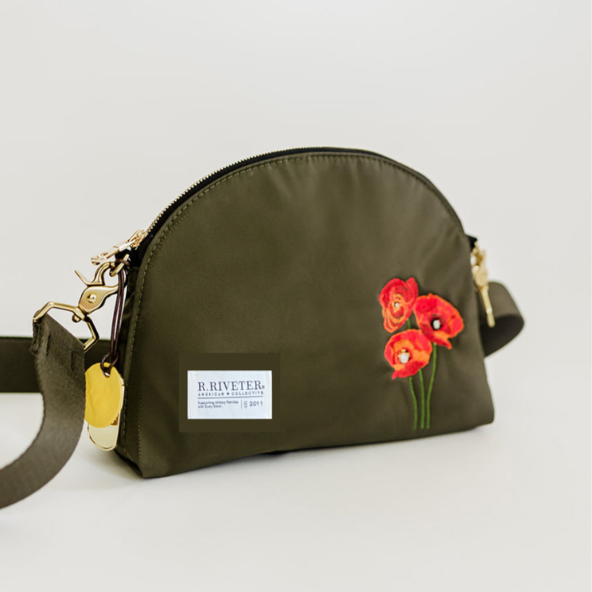 Olive nylon zip pouch with red flower embroidery and front label, crossbody strap