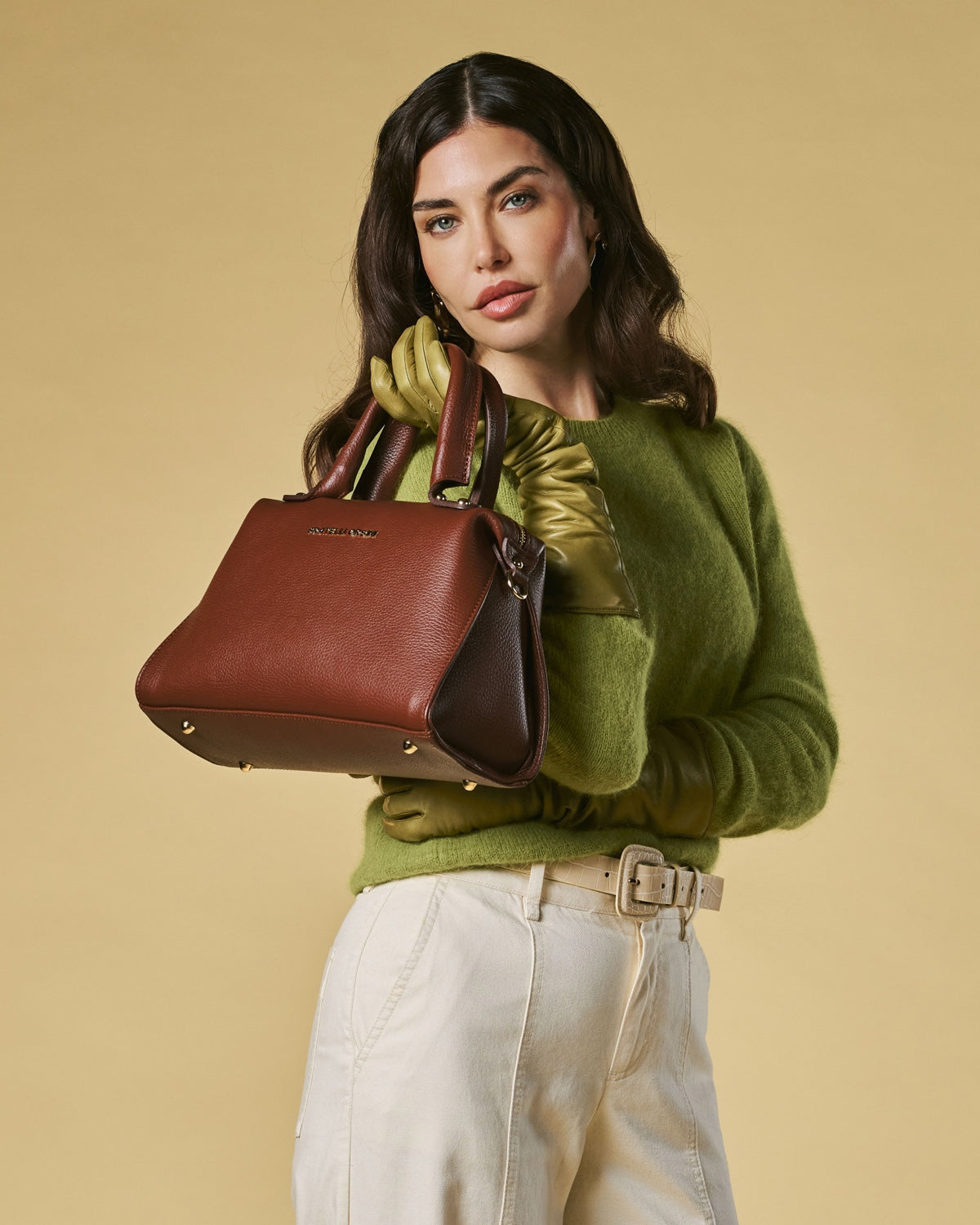 Brown leather zip-top handbag with top handles and gold-toned hardware