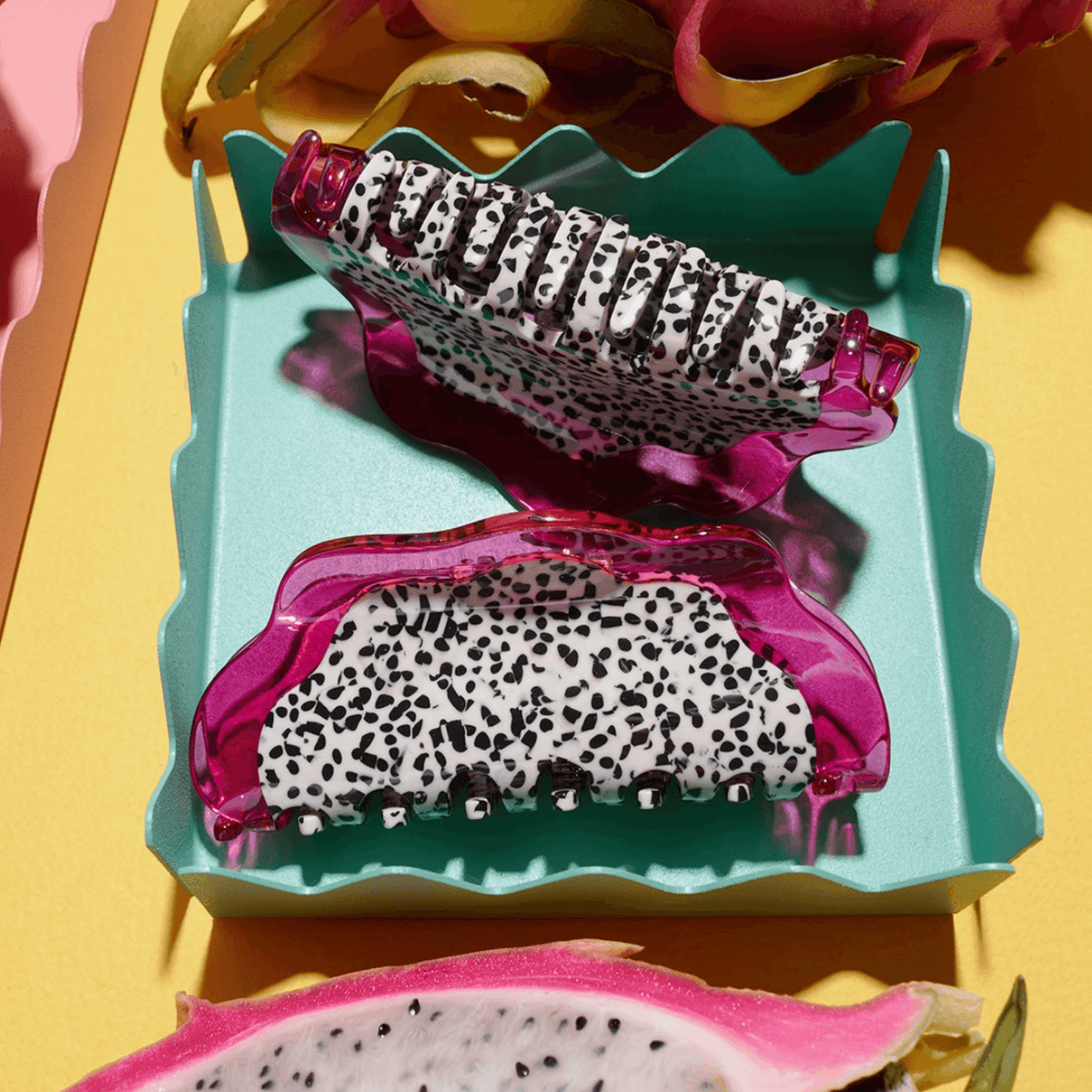 Two dragon fruit hair claws, pink frames with leopard-print grip teeth