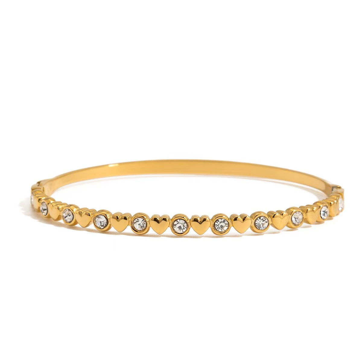 Gold hinge bangle bracelet with heart and round stone details along the band