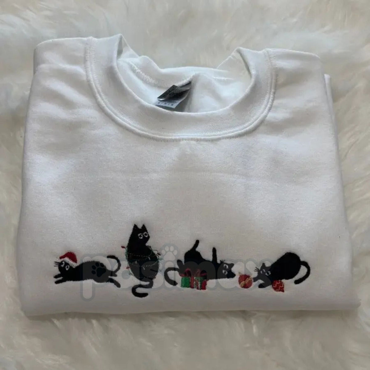 White crewneck sweatshirt with black cat holiday embroidery across the chest