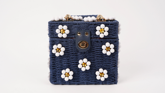Navy woven mini tote bag with white flower appliques and gold clasp front
