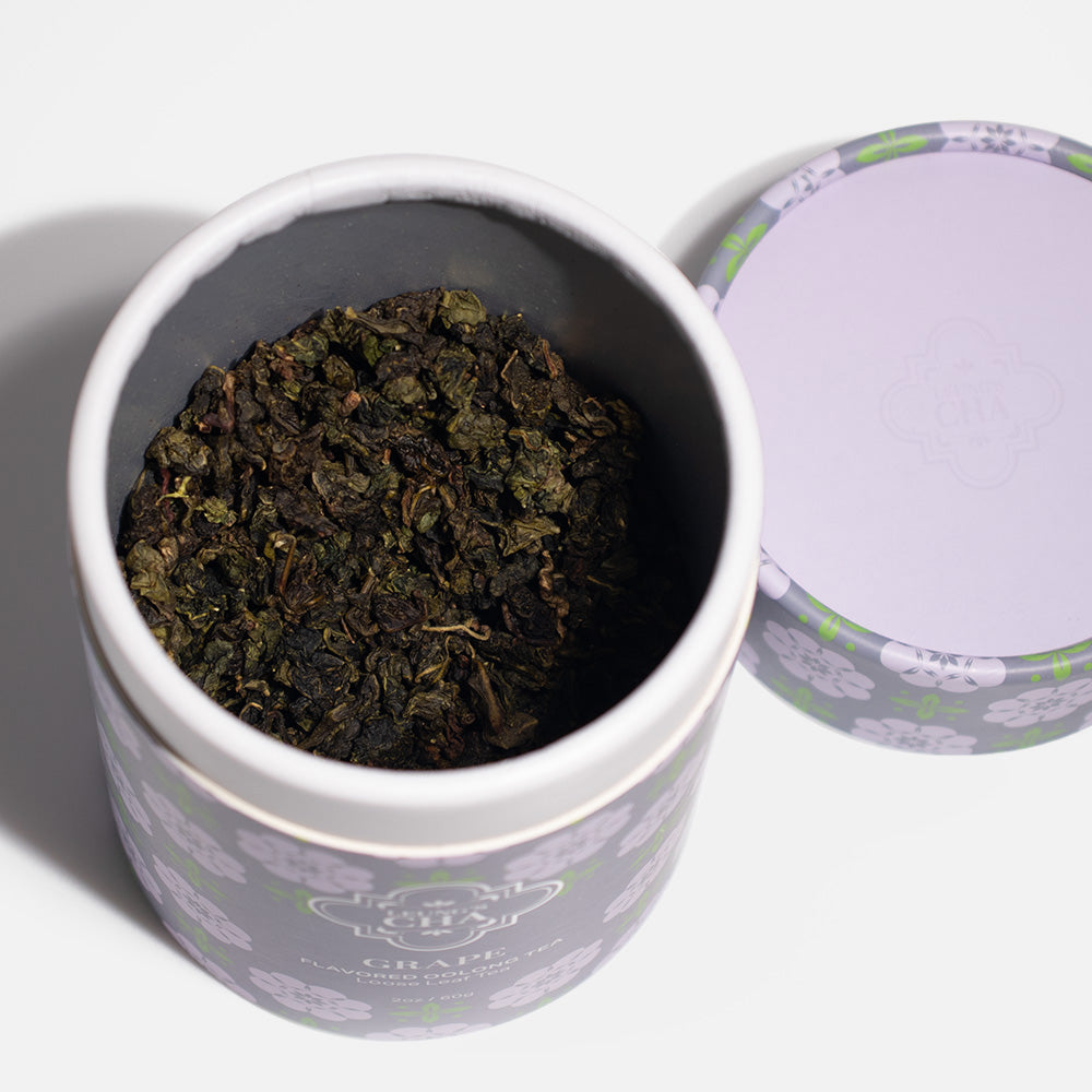 Opened flavored oolong tea canister showing dark loose tea leaves inside