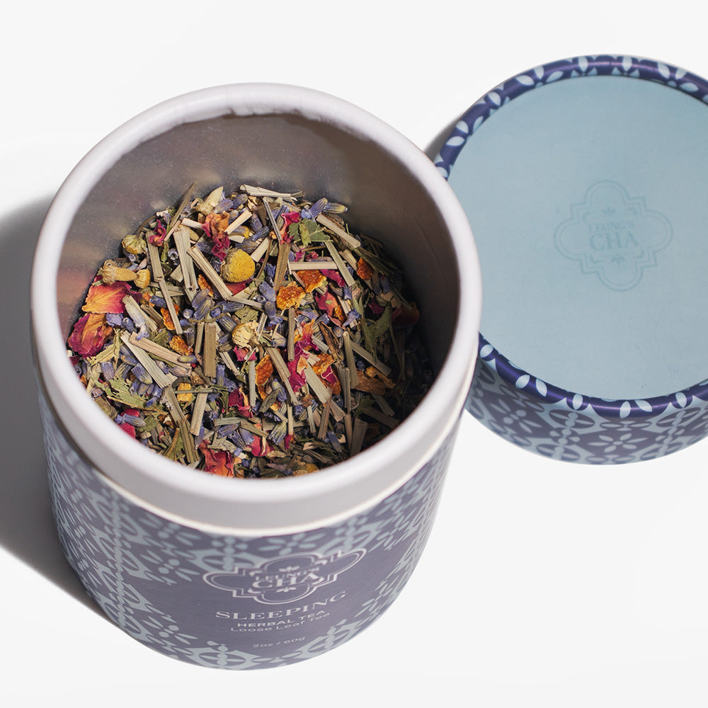 Opened blue sleeping herbal tea tin showing loose dried herbal tea leaves inside