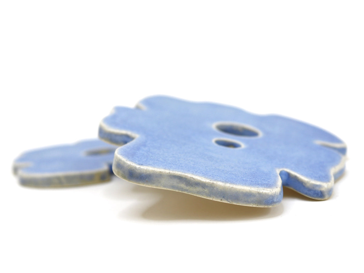 Close-up of a light blue frog-shaped decor piece with a round cutout