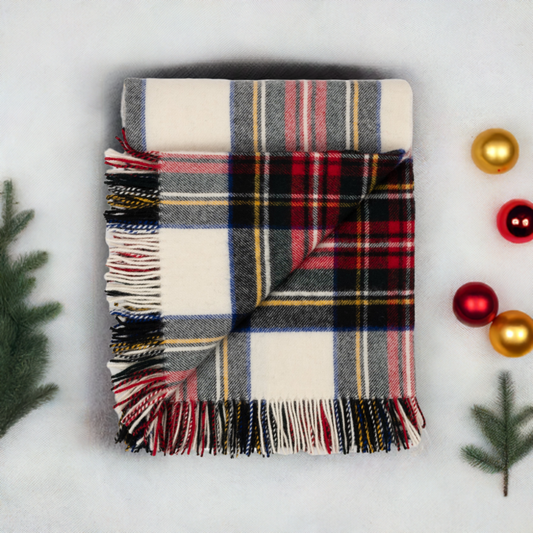 Folded plaid lambswool throw with fringes, red and navy tartan over cream and gray