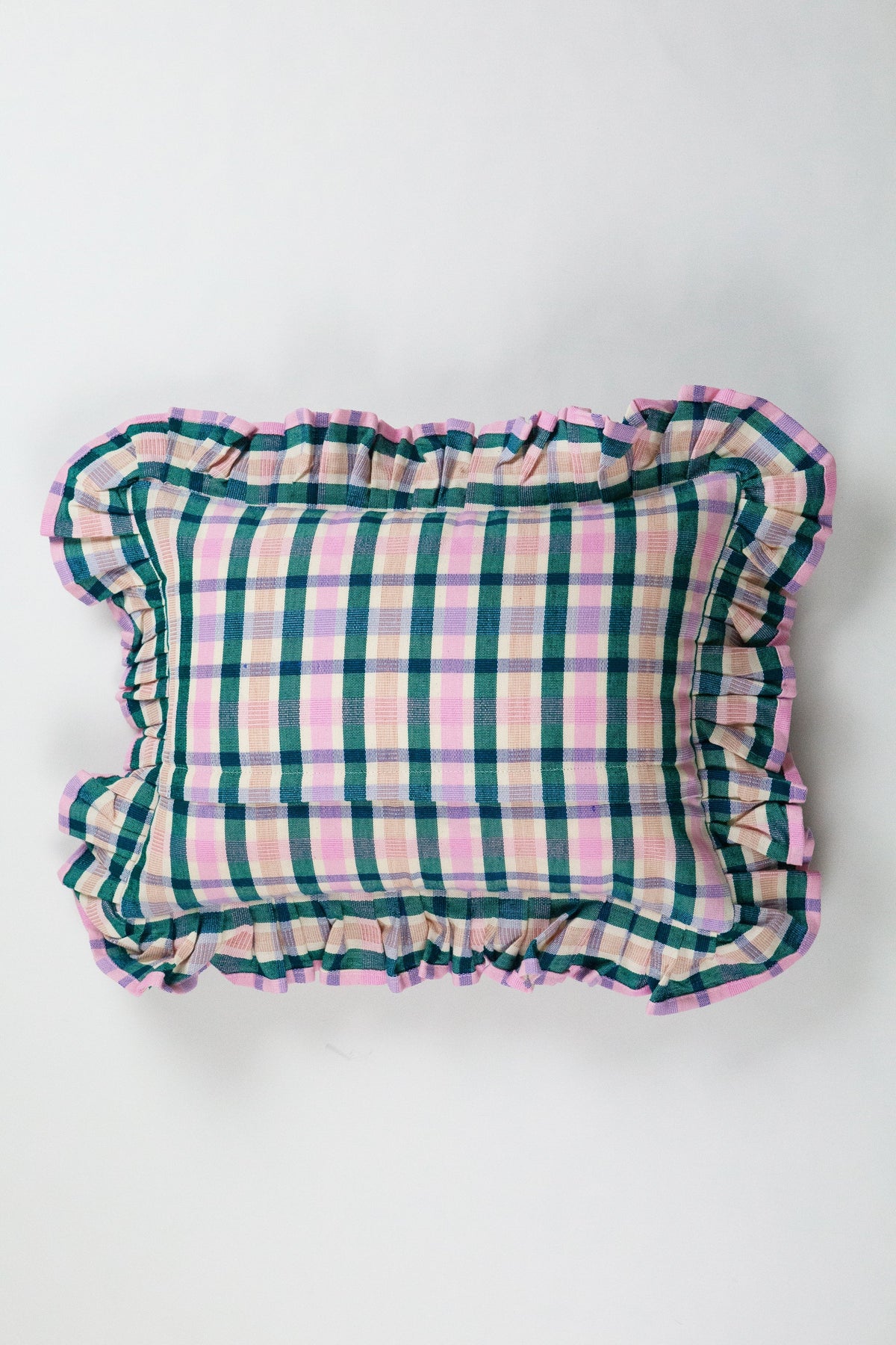 Plaid ruffle pillow with gathered border in multicolor grid pattern