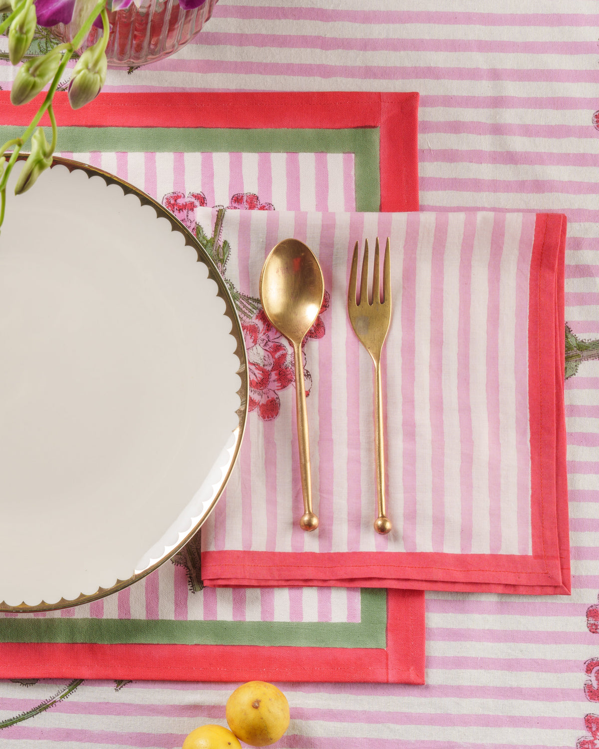 Pink striped napkins with hydrangea print panels and red napkin-edge trim