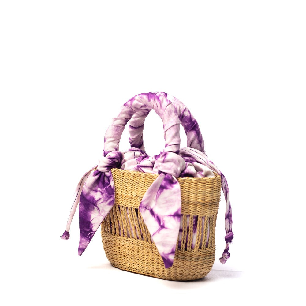 Mini woven straw tote with purple tie-dye scarf handles and side tassel ties