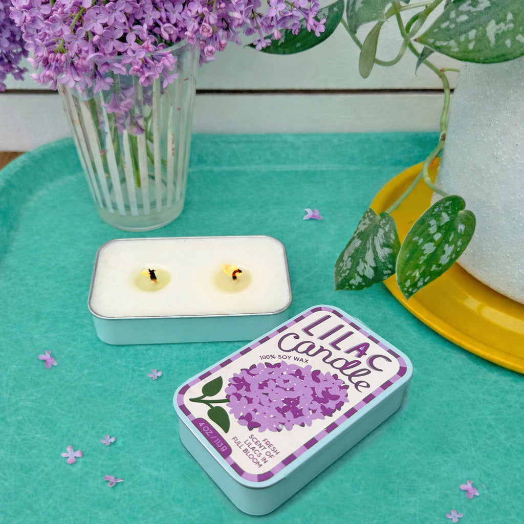 Two soy candle tins: lilac tin and basil tin, with white wax visible in tins.