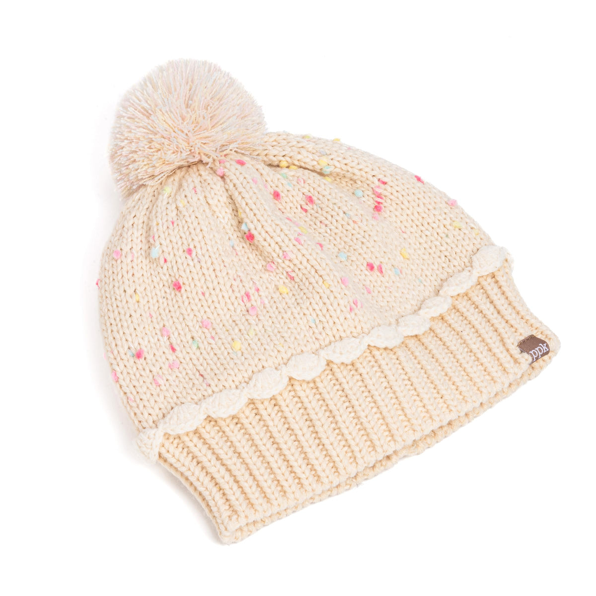 Angled view of pale speckled knit beanie with ribbed cuff, scalloped trim, and pom-pom