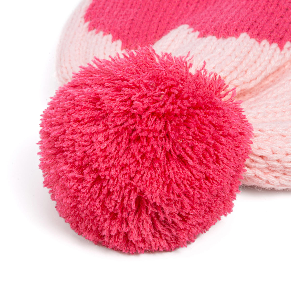 Close-up of the fluffy pink pom-pom on a knitted winter hat