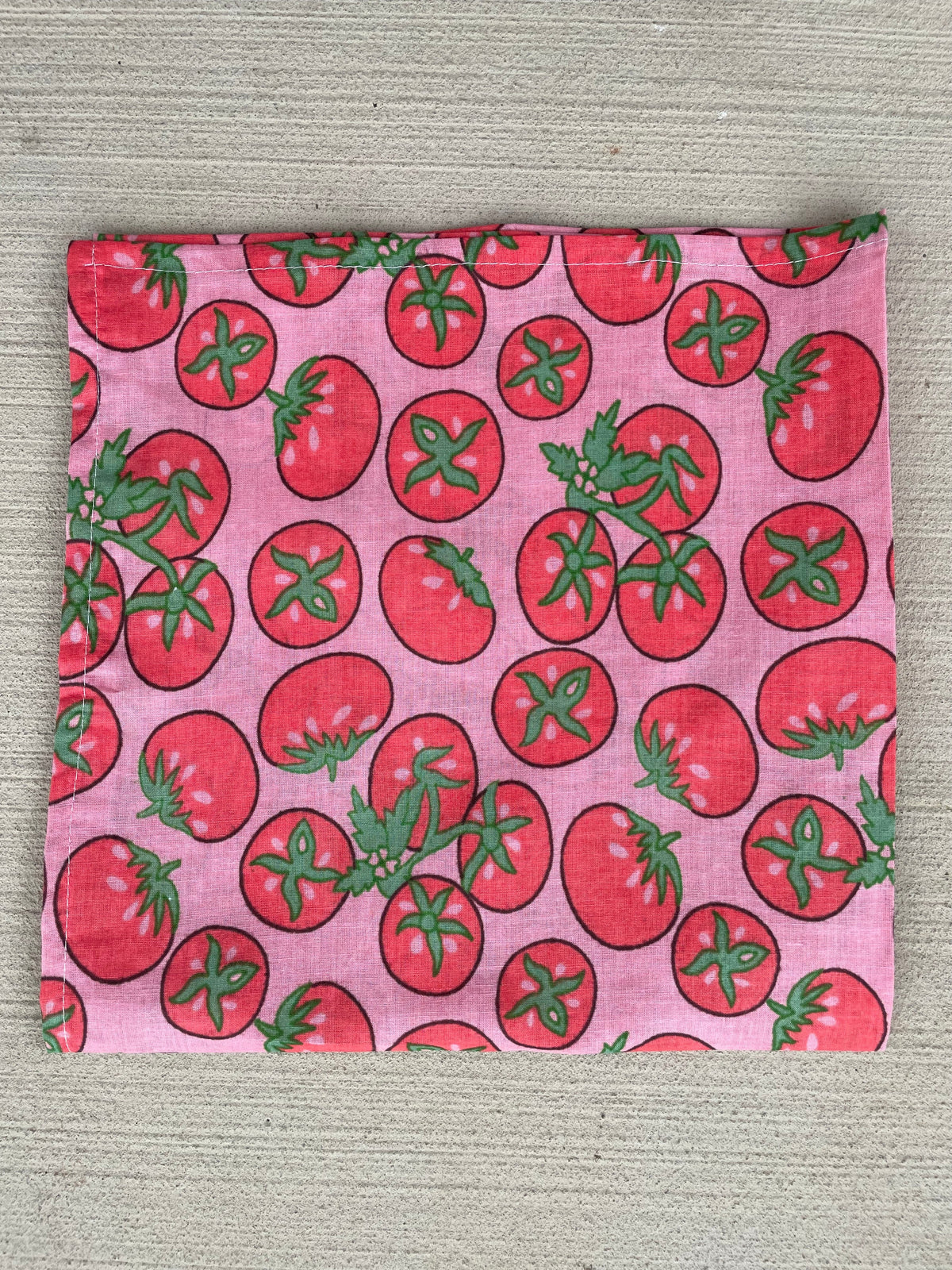 Tomato pink bandana scarf fabric square with scattered strawberry and leaf print