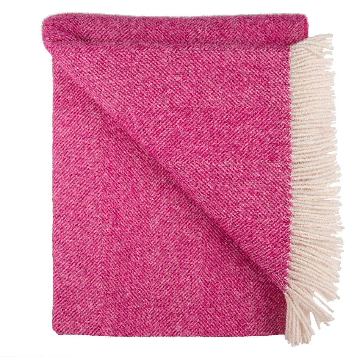 Pink herringbone throw folded, draped corner and cream fringe trim