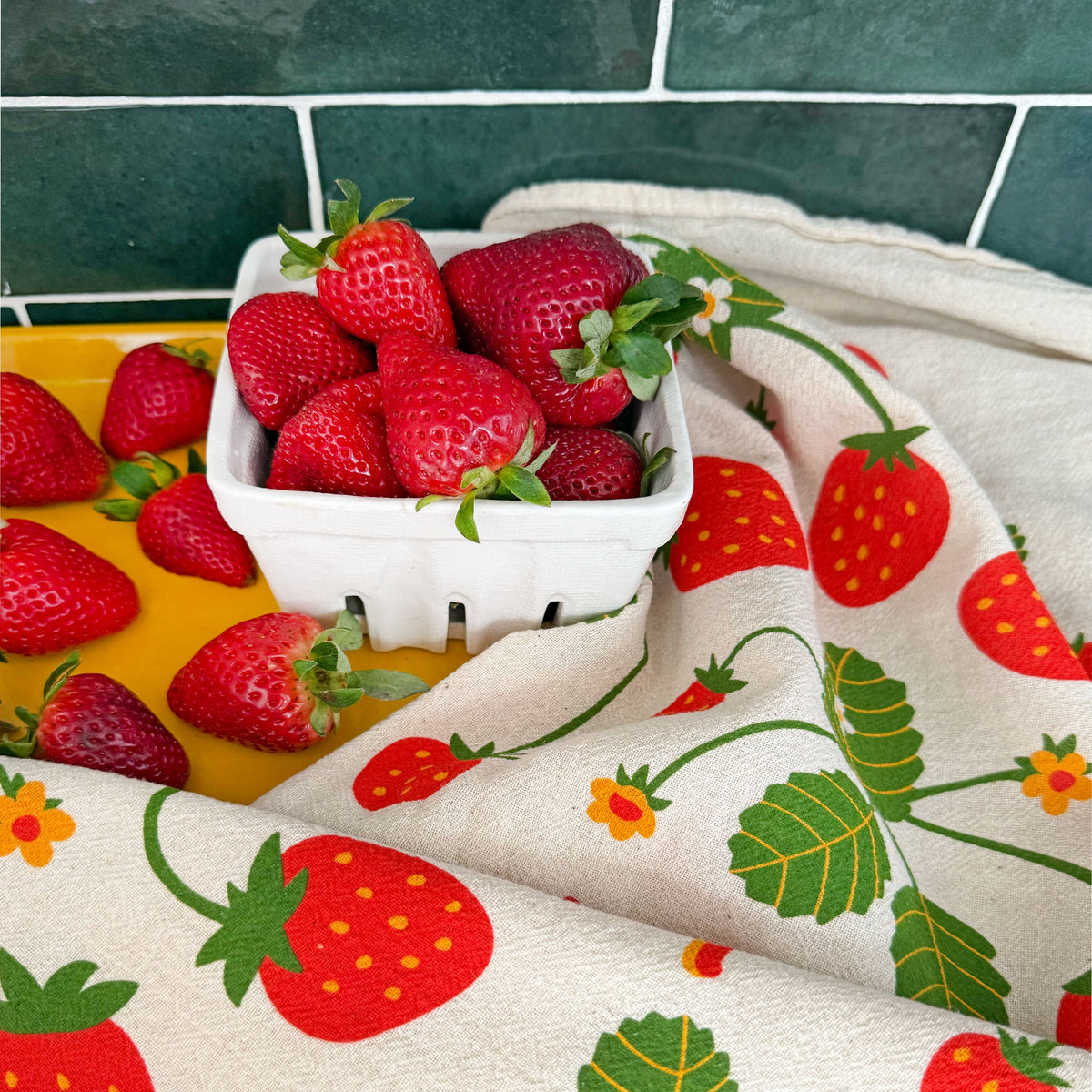 Cream towel with strawberry vine print, red berries, and green leaves