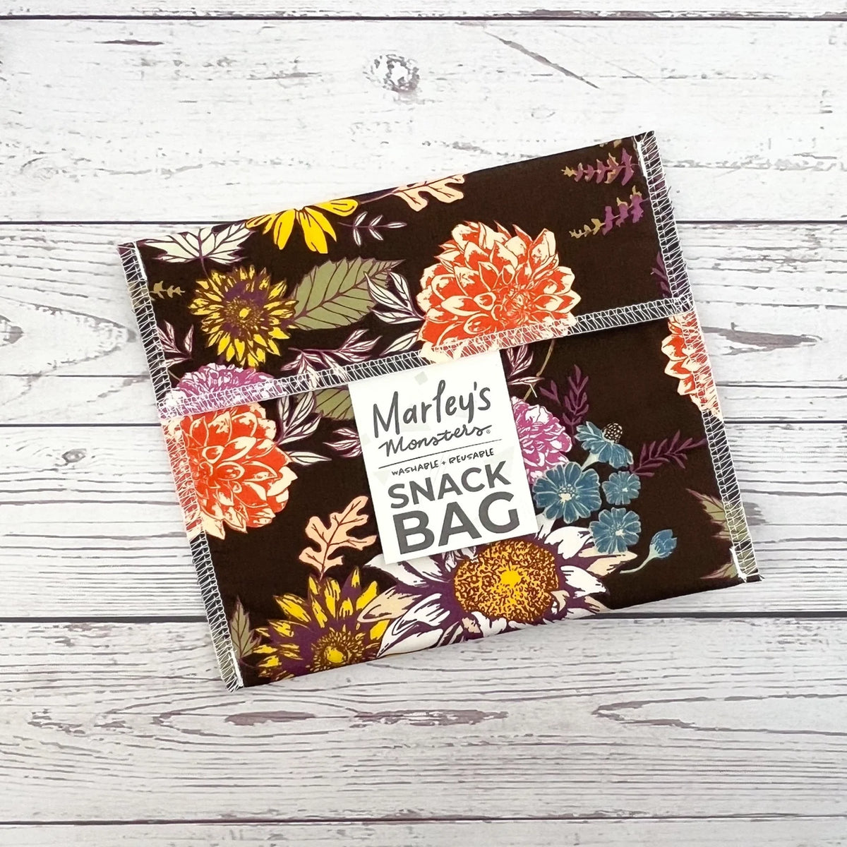 Reusable snack bag with dark floral botanical print and multicolor decorative border