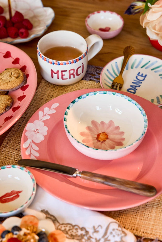 Ceramic bowl with hand-painted soft pink flower, teal speckled rim and scalloped edge