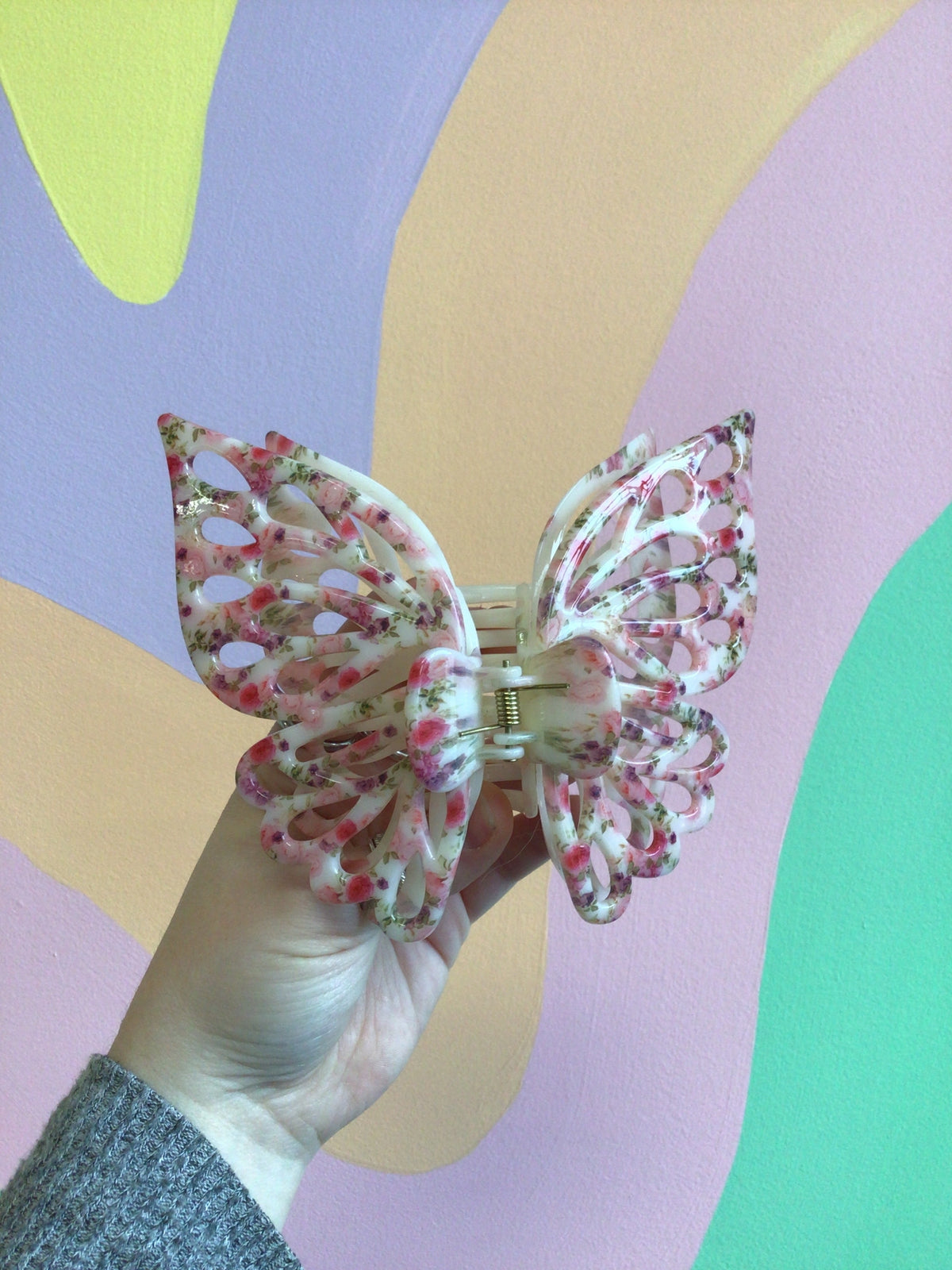 Pink and purple butterfly hair claw clip with curved metal teeth