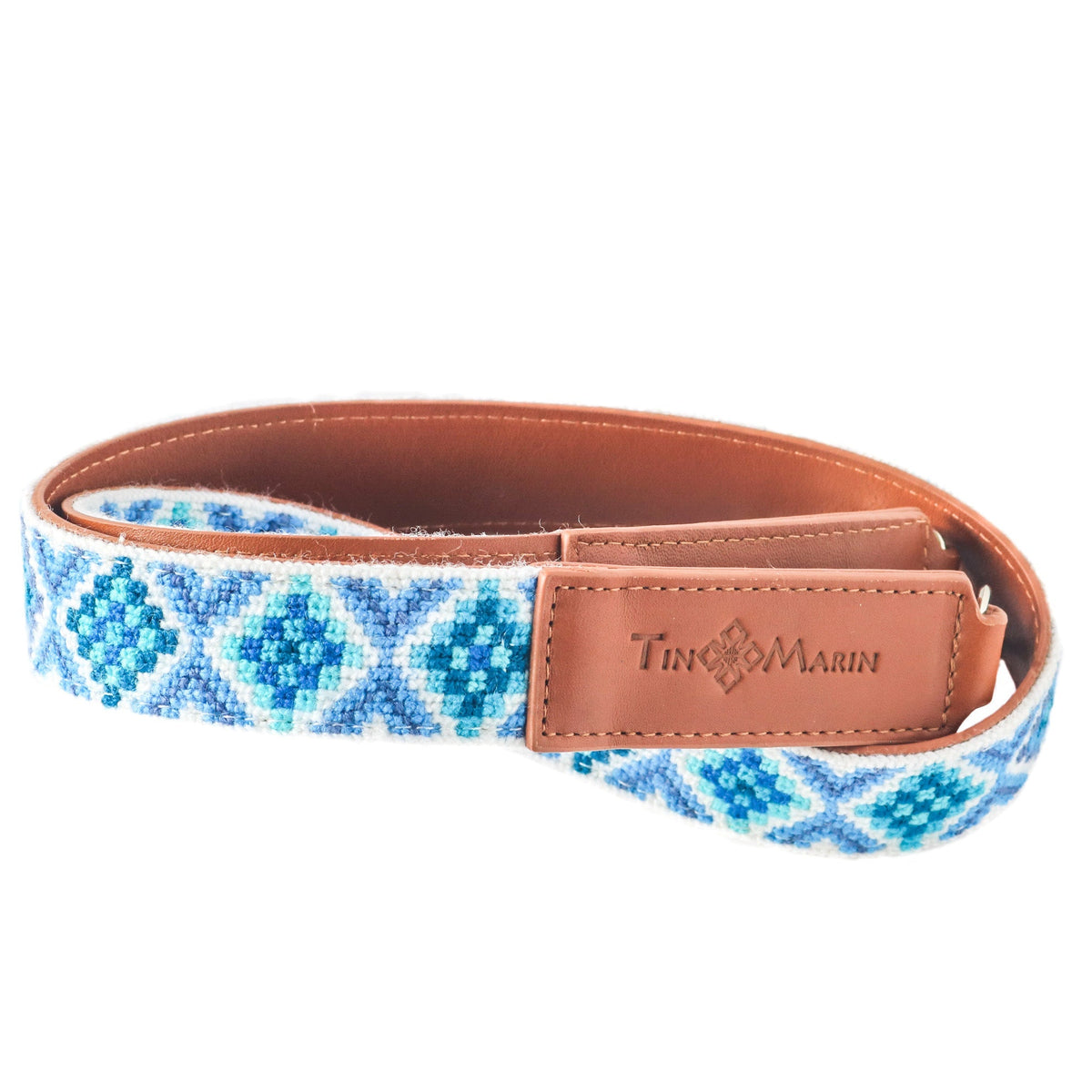 Blue woven bag strap with tan leather logo tab and smooth leather inner lining